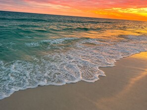 A beach with waves gently lapping onto the shore. - Sun Rays Retreat - Hot Tub - Walk to the Beach - Pet Friendly - Sleeps 10 (Panama City Beach)