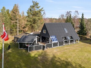 A residential property with a main house and attached structures, surrounded by a fenced area and trees. - "Ilsebeth" -  from the sea by Interhome (Hals)