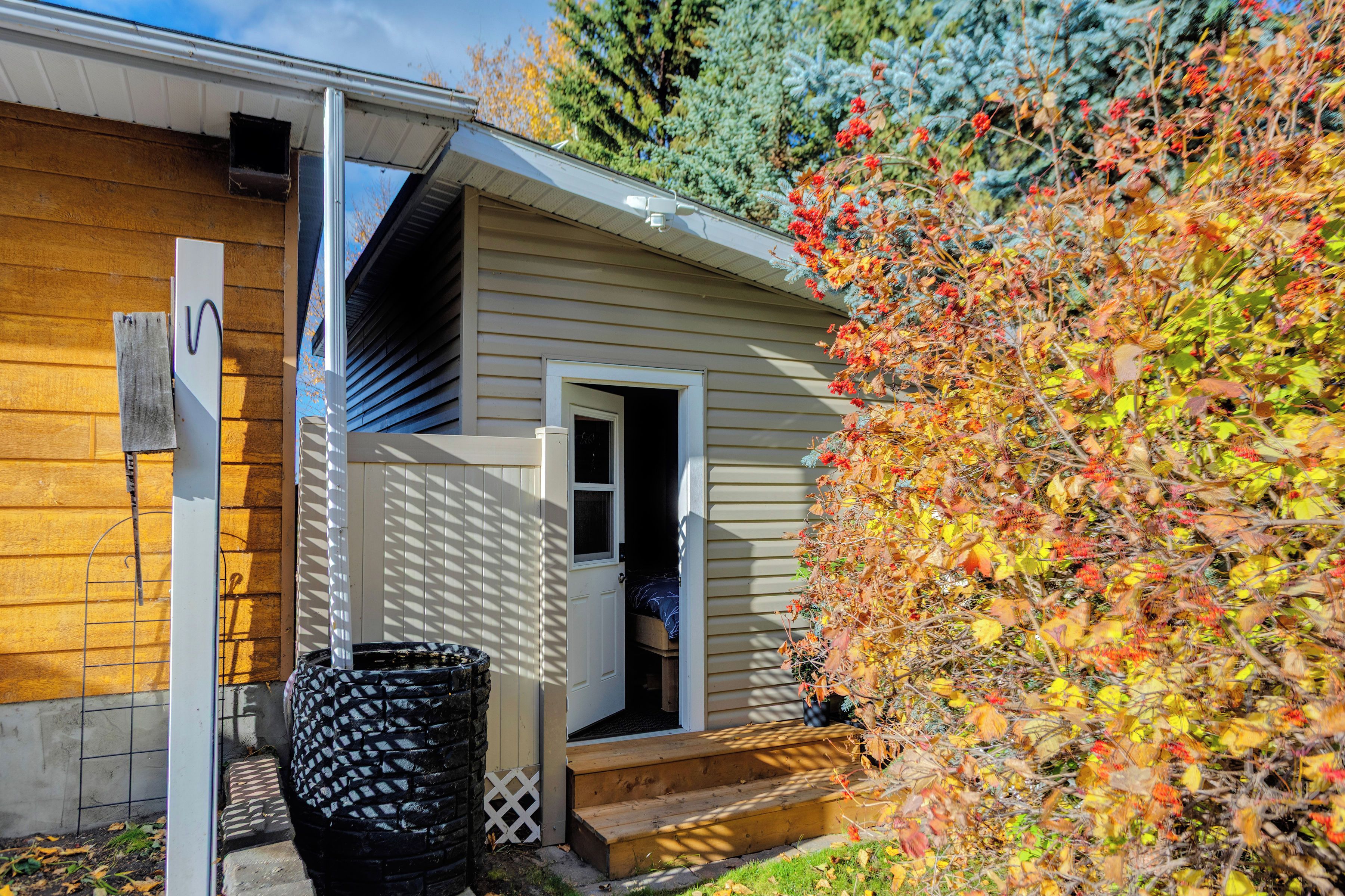 A house with a wooden exterior, a visible door, and a small porch.