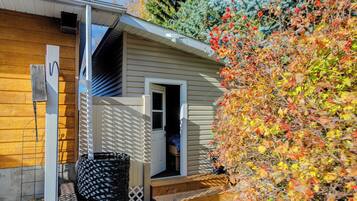 A house with a wooden exterior, a visible door, and a small porch.