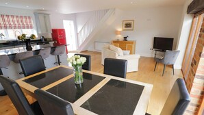 A modern living space with a dining area, kitchen, and seating area. - UNDERHILL HOUSE ANNEX, pet friendly in Stratford-Upon-Avon (Stratford-upon-Avon)
