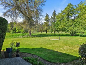 A well-maintained park with a variety of trees, a clear sky, and a grassy area with a concrete path. - Mt Hood Condo Near Skiing & Golf Hawaiian-Inspired (Mount Hood Village)