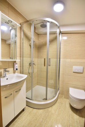 A modern bathroom with a glass-enclosed shower, a white sink, and a toilet. - Charming 2-bedroom Apartment With Stunning Views in Vir (Vir)