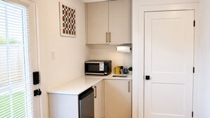A compact kitchen with a microwave, sink, and dishwasher. - Luxury 1BR Private Suite • Private Entry • Houston Getaway (Houston)