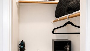 A closet with shelves, a coat rack, and a microwave. - Luxury 1BR Private Suite • Private Entry • Houston Getaway (Houston)