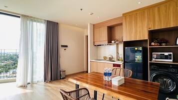 A modern kitchen with wooden cabinets, a built-in microwave, and a washing machine.