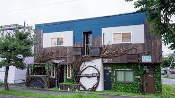 A building with a sign for 'Capricious Inn' and an entrance marked 'Exit & Entrance.'