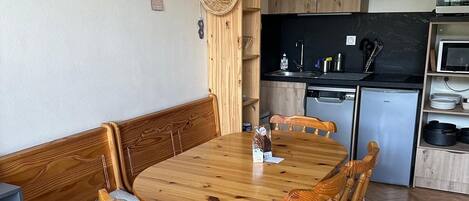 A compact kitchen with a microwave, sink, and a refrigerator.