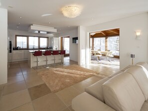 A modern living space with a kitchen, dining area, and a large window. - Apartments Grischuna Mountain Lodge, (Samnaun-Dorf) by Interhome (Samnaun)