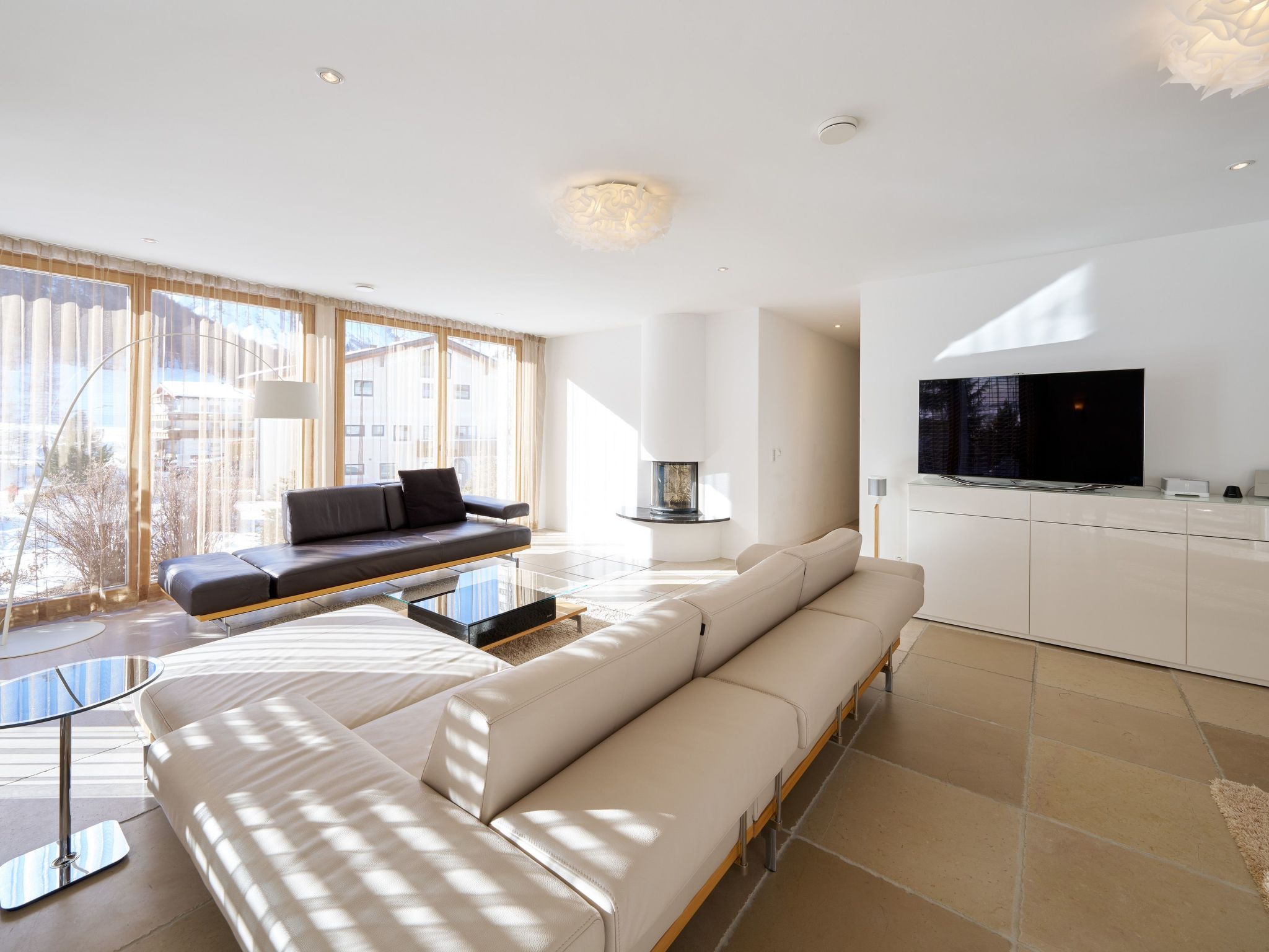 A modern living room with a sofa, a coffee table, and a TV.