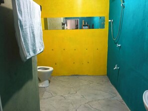A bathroom with a toilet, a mirror, and a shower area. - Ayana Eco Rest Dambulla (Dambulla)