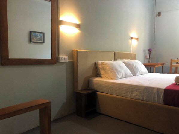 A hotel room with a bed, bedside table, nightstand, and wall-mounted light fixtures. - Ayana Eco Rest Dambulla (Dambulla)