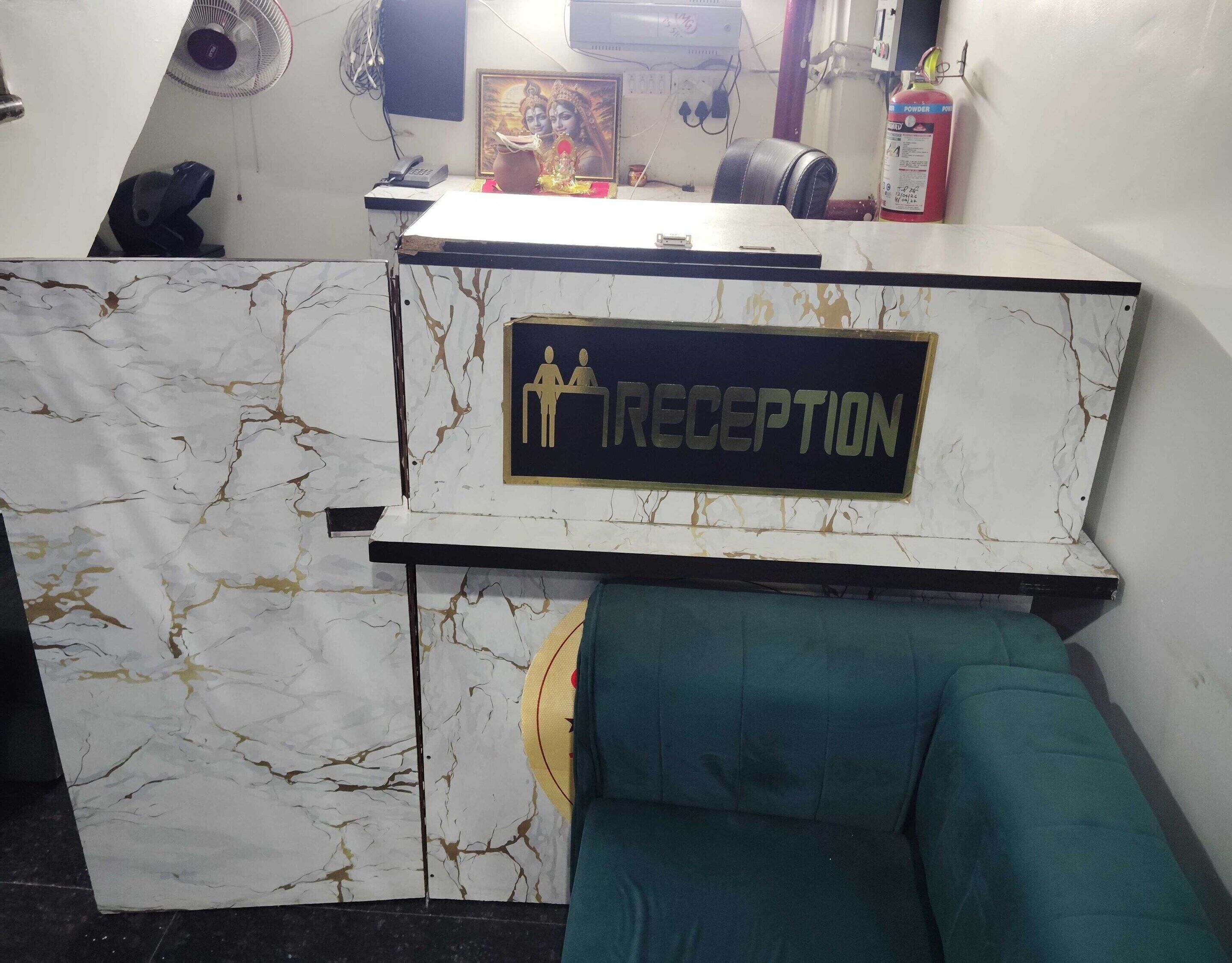 A reception desk with a marble design and a sign indicating a reception area.