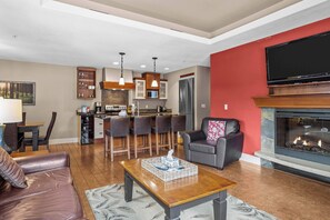 A modern living room with a fireplace, a dining area, and a kitchen. - The ‘106’ by Fern James
Adventure Awaits! (Canmore)