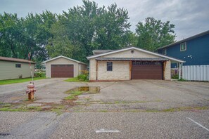 A residential property with a garage, a small attached building, and a fire hydrant. - West Okoboji Waterfront Home w/ Private Dock (Milford)