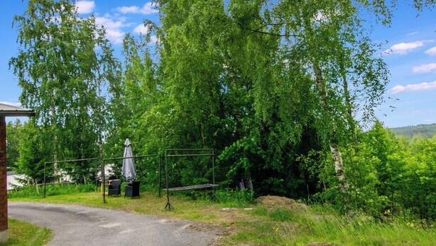 A rural road with a picnic area and a statue.