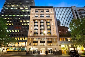 A multi-story building with a classic architectural style, featuring a central entrance with a large glass facade. - Temple Court Suite in Melbourne CBD (Melbourne)