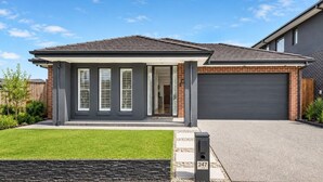 A modern two-story house with a covered porch, a garage, and a well-maintained lawn. - Spacious 4-Bedroom Family Home in Manor Lakes (Manor Lakes)