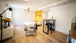 A modern bedroom with a bed, a desk, and a chair.