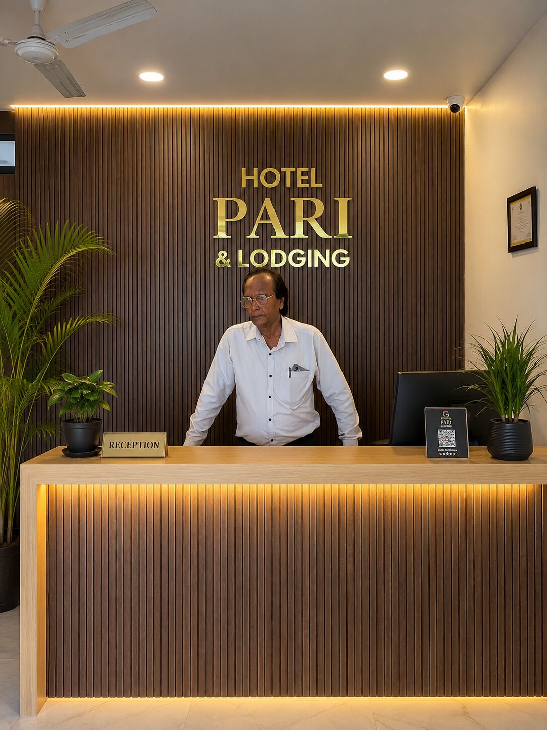 A reception desk with a sign reading 'HOTEL PARI & LODGING.'