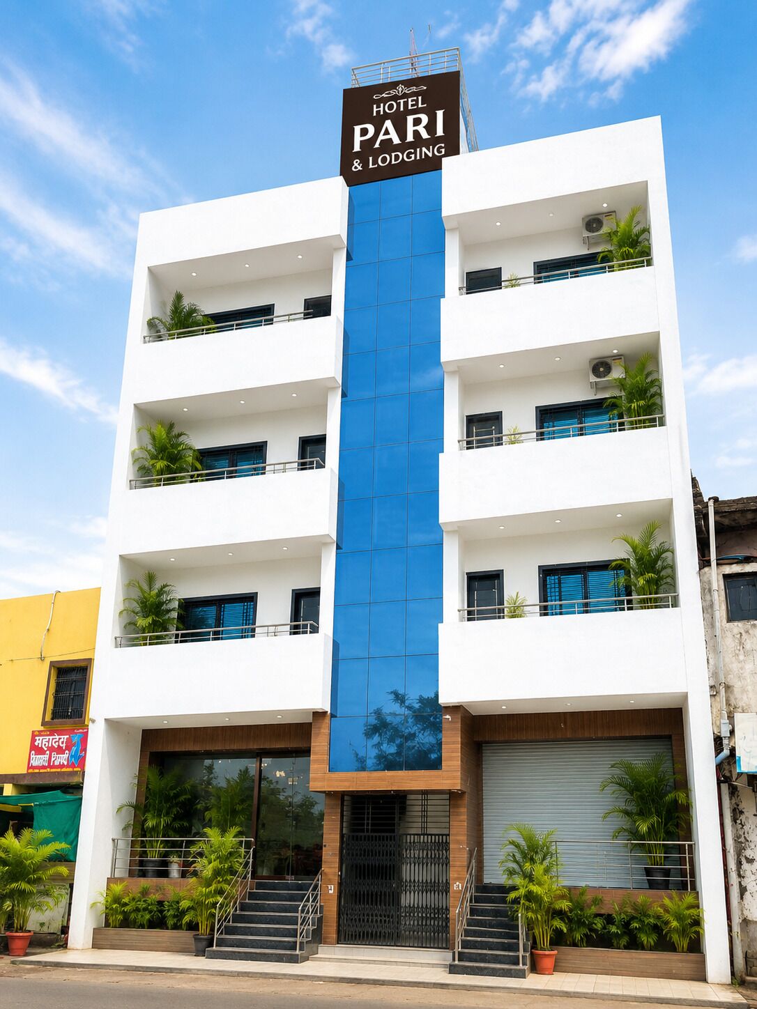 A multi-story hotel building with a prominent sign reading 'HOTEL PARI & LODGING'.