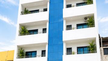 A multi-story hotel building with a prominent sign reading 'HOTEL PARI & LODGING'.