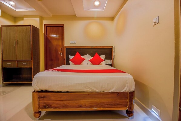 A bedroom with a wooden bed frame, a wardrobe, and a ceiling light.