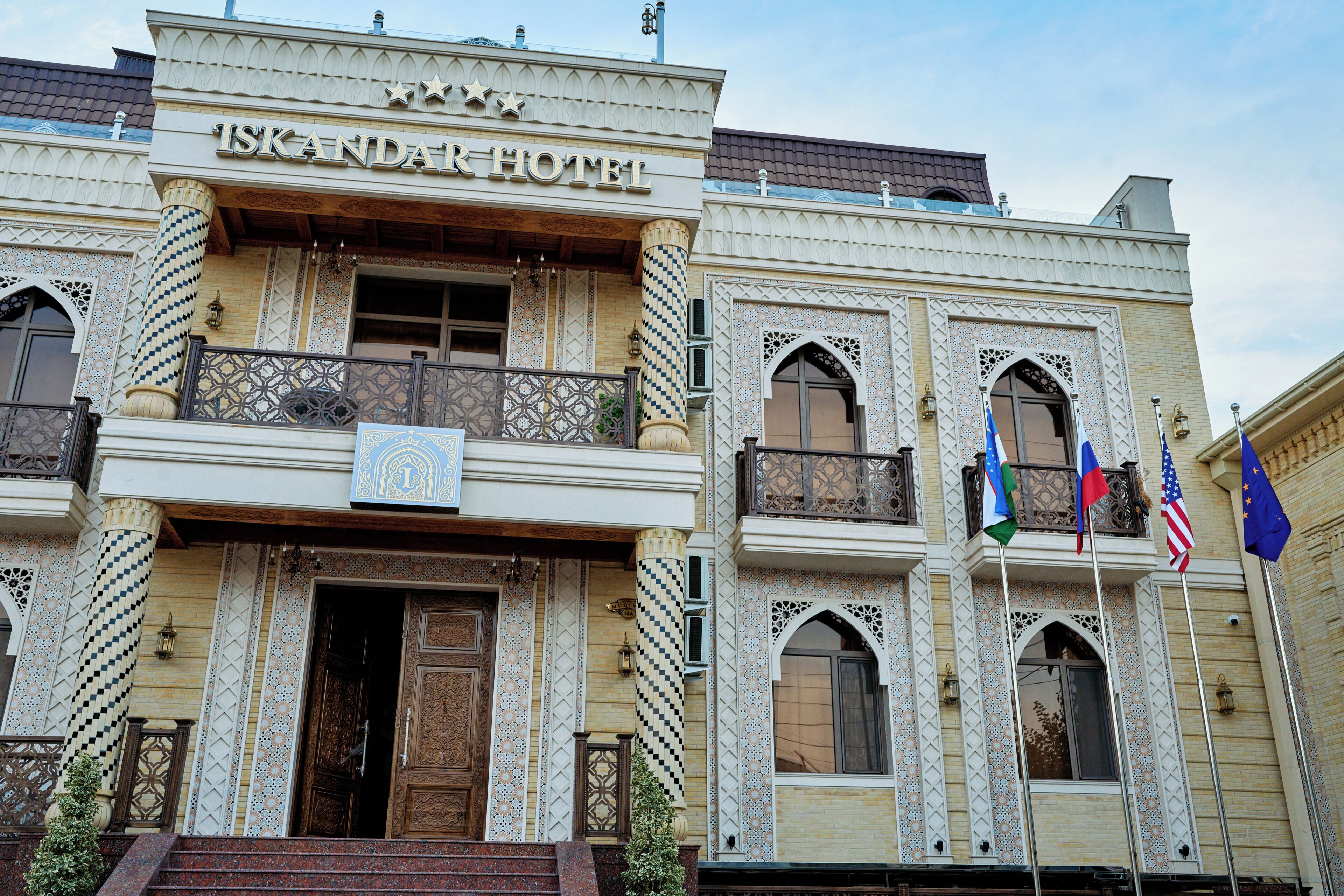 A building with the sign 'ISKANDAR HOTEL' indicating it is a hotel.