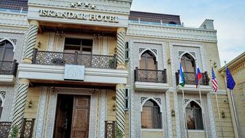 A building with the sign 'ISKANDAR HOTEL' indicating it is a hotel.
