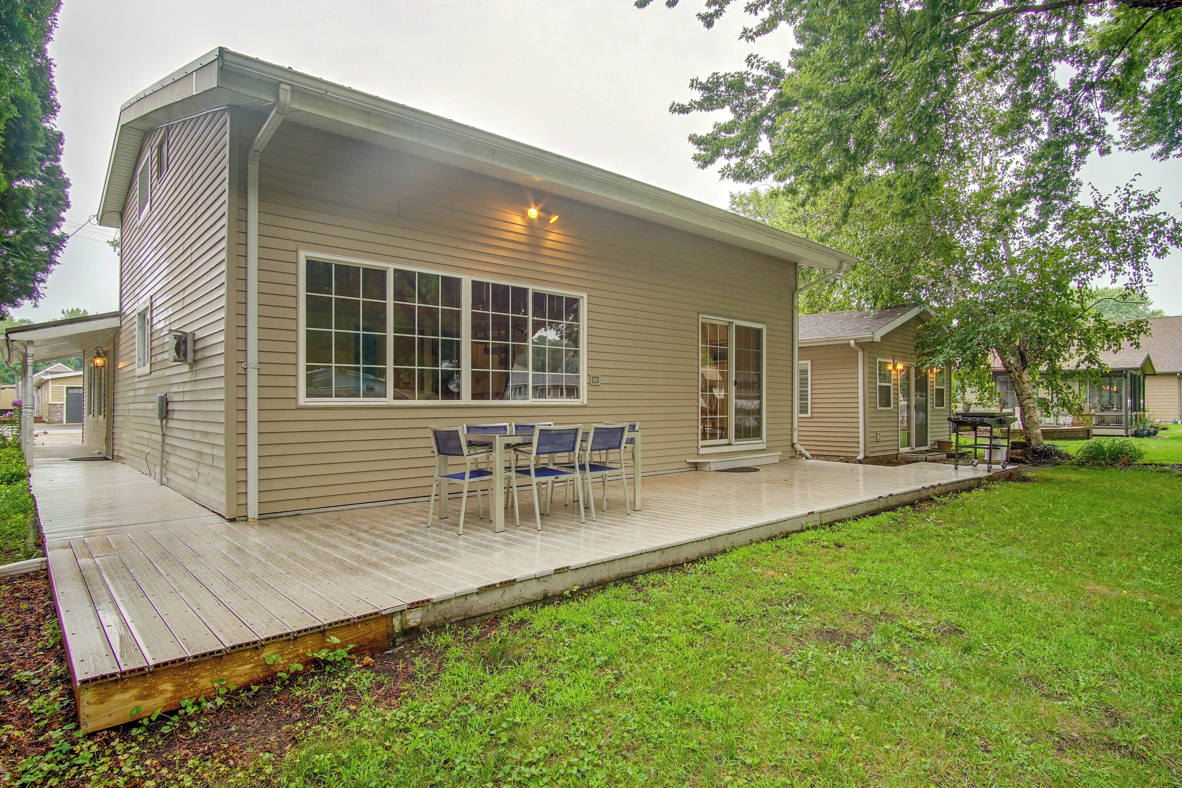 A single-story house with a covered porch and a small deck area.