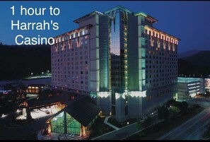 A multi-story hotel building with a prominent glass facade and a well-lit entrance.