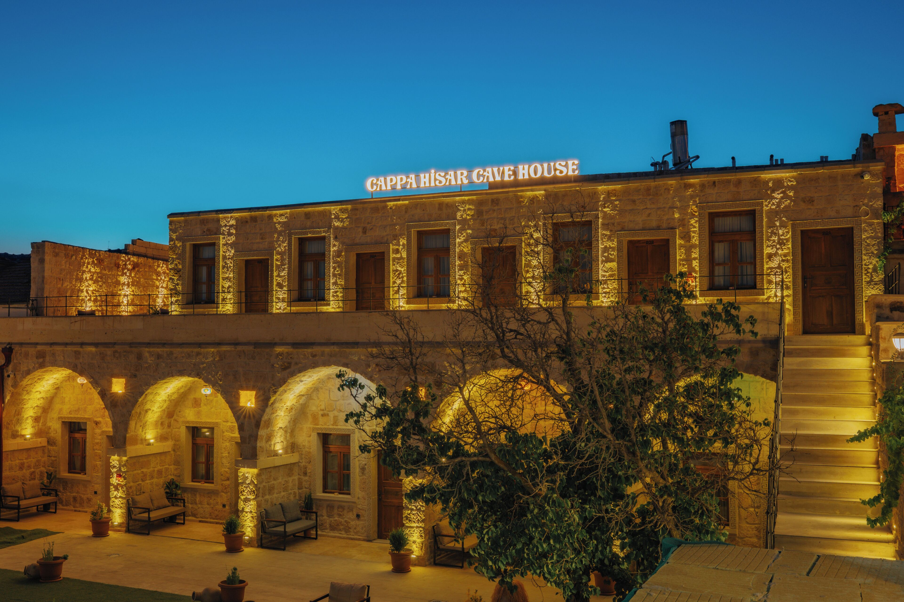 A stone building with a sign reading 'Cappahira Cave House' at the top.