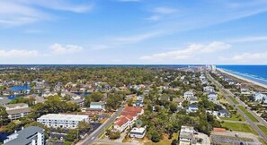 A coastal town with a beach, residential buildings, and a large body of water. - 4/2 bottom floor 1 block from beach (North Myrtle Beach)