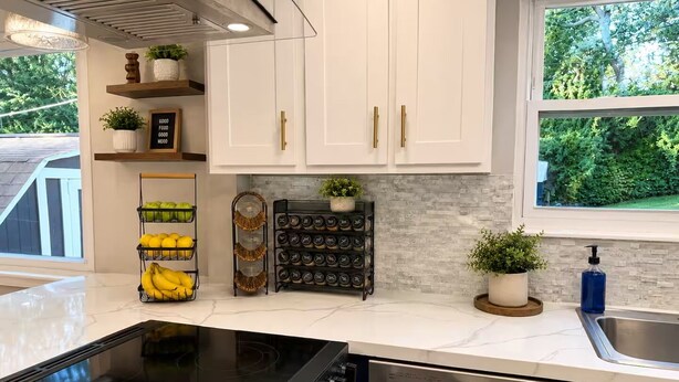 A modern kitchen with white cabinets, a black stove, and a stainless steel dishwasher. - Spacious Family Retreat with Several Living Areas, Backyard with Patio & Pool (Dayton)