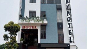 A multi-story hotel with a prominent sign reading 'HOTEL' and 'LUXURY HOTEL' on the facade.