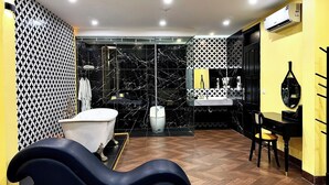 A modern bathroom with a bathtub, a shower, and a vanity with a mirror.