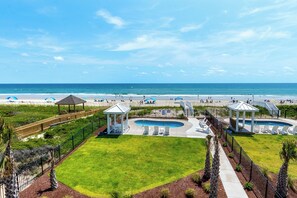 A beach resort with a swimming pool, gazebos, and beach umbrellas. - Oceanfront Luxury 8BR w/ Pool, Hot Tub, Theater, Game Room & Elevator (Atlantic Beach)