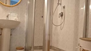 A bathroom with a glass-enclosed shower, a sink, and a mirror. - Charming Apartment in Vernazza IT011030C25E7RWJXG (Vernazza)