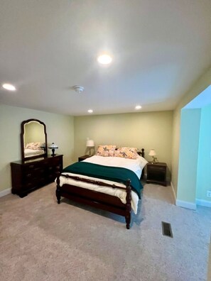 A bedroom with a bed, dresser, nightstands, and a mirror. - Spacious 4-Bedroom Pet-Friendly Home Near Antietam & Historic Sharpsburg (Sharpsburg)