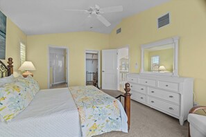 A bedroom with a bed, dresser, mirror, and ceiling fan. - 4 Bedroom, 3.5 Bath with Pool Vacation Home in The Dunes (Sanibel)