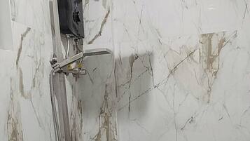 A bathroom with a shower, toilet, and sink.