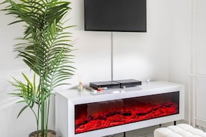 A modern bathroom with a white vanity, a large mirror, and a red heated floor feature. - Modern Loft with Private Spa (Mulhouse)