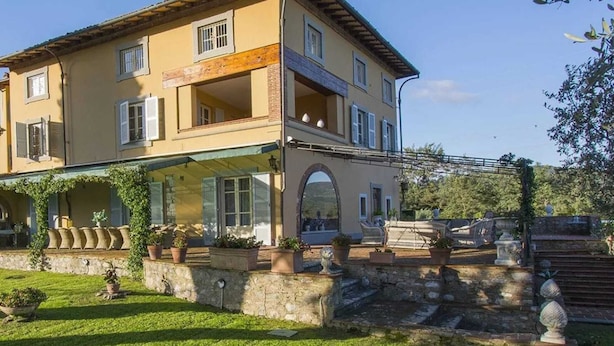 A two-story building with a glass balcony, stone steps, and a garden. - Villa Near Lucca With Private Pool (Lucca)