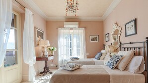 A bedroom with a bed, bedside tables, a mirror, and a chandelier. - Villa Near Lucca With Private Pool (Lucca)