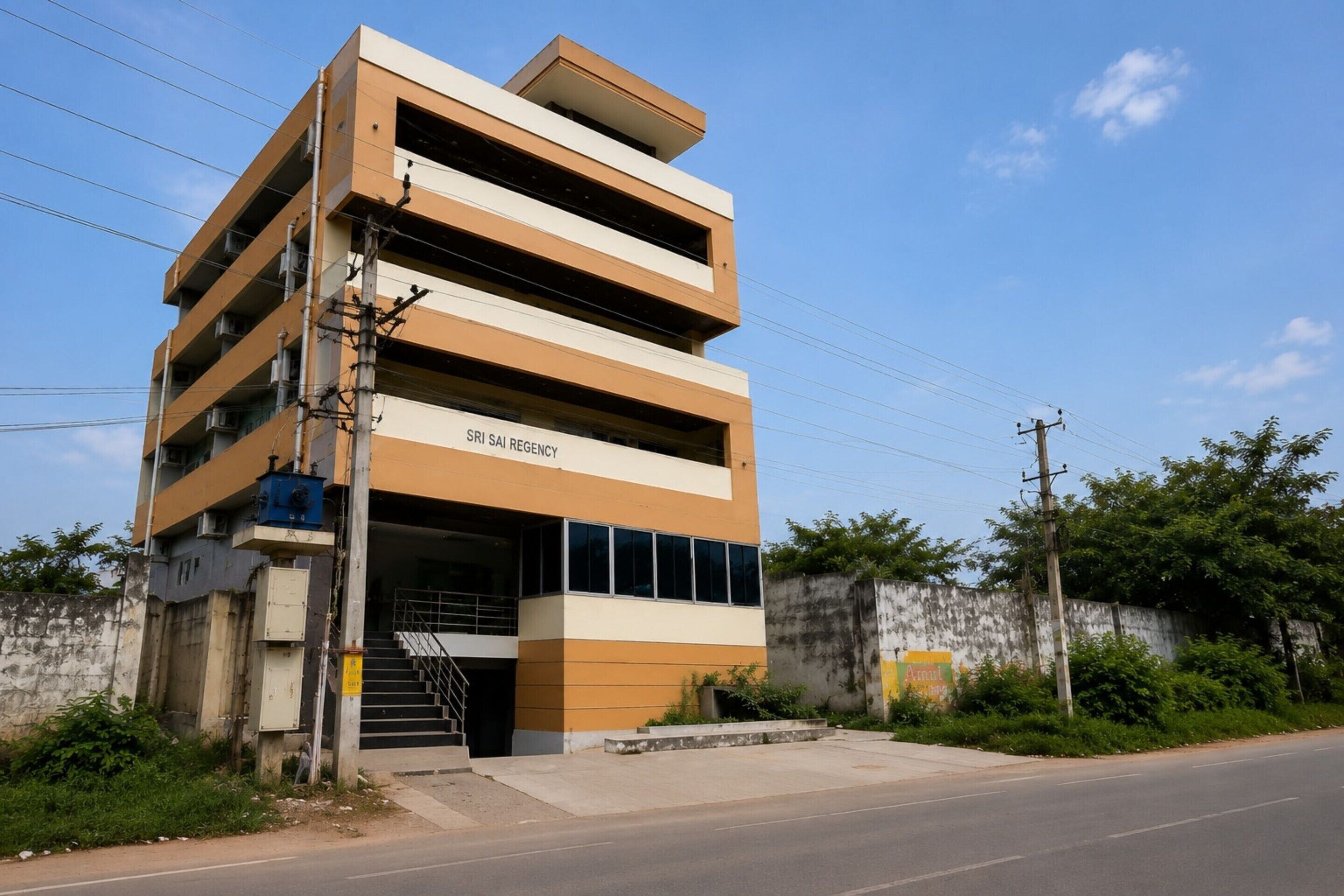 A multi-story parking garage with a sign indicating it is a SRI SAL REGENCY.