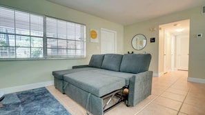 Spacious living room with comfortable seating and a Smart TV. - 1BR Sunrise Oasis with Pool Near Beach & Las Olas (Fort Lauderdale)