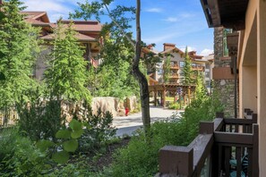 A resort with multiple buildings, a covered outdoor area, and a paved walkway. - The Suite Life (with AC unit!) by Cottonwood Lodging (Brighton)