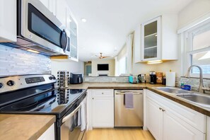 A modern kitchen with stainless steel appliances, a dishwasher, and a microwave. - Casa Del Mar - Designer Home, 1 Block to Beach (Del Mar)