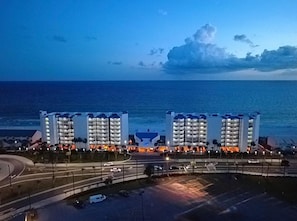 A hotel with multiple floors and balconies, located near a body of water. - Sea Forever at Aquavista 406 E- W PCB - Beachfront (Panama City Beach)