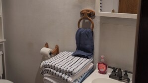 A bathroom with a toilet, a sink, and a mirror. - Adorable studio with AC in charming Winfield (Winfield)